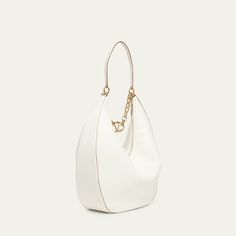 Valentino Garavani hobo bag in leather Leather shoulder strap with hanging VLOGO chain strap  Zip top closure  Lining: Leather Approx. 19.3"H x 19.5"W x 5.1"D Made in Italy Leather Hobo Bag, Leather Hobo, Zip Top, Hobo Bag, Valentino Garavani, Chain Strap, Tops Designs, Shoulder Strap, In Italy