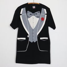 Original 1990s Tuxedo Costume Shirt. This is a true vintage shirt, not a modern reproduction. Sizes vary so please use measurements for best idea on fit. No back graphics. Shirt is in excellent condition, no holes, no stains. This shirt comes laundered and ready to wear. Tag Size: Large Material: 100% Cotton Pit to Pit: 20.5 inches Collar to Hem: 30.5 inches Black Formal Shirt With Graphic Print, Vintage Graphic Print Party Tops, Retro Formal Cotton Tops, Vintage Short Sleeve Party T-shirt, Vintage Cotton T-shirt For Party, Vintage Fitted Crew Neck Shirt, Vintage Graphic Print Party Shirt, Quick Halloween Costumes, Graphics Shirt