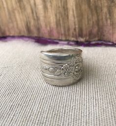 a silver ring sitting on top of a rug