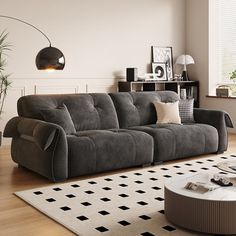 a living room filled with furniture next to a large white rug on top of a hard wood floor