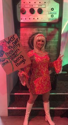 a woman in a red dress holding a sign