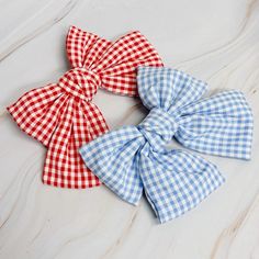 Add a touch of sweetness to any hairstyle with our Gingham Bow Pretty Bow Hair Clip. The adorable gingham pattern and perfectly pretty bow make it great for everyday wear and more formal occasions. Its barrette clip ensures a secure and comfortable fit.Dimensions: approximately 6" x 6"Made In: China Bow Hair Clip, Gingham Pattern, Hair Collection, Blue Gingham, Bow Hair, Brand Collection, Barrette Clip, Bow Hair Clips, How To Make Bows