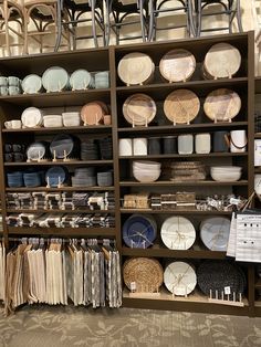 the shelves are full of dishes and plates