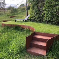 a set of steps in the grass next to a bench