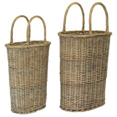 two large wicker baskets with handles on each side, one is empty and the other has