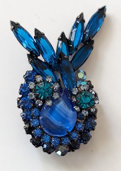 "This is a verified  Delizza and Elster Juliana brooch made of japanned  metal and set with a variety of rhinestones in shades of Bermuda blue, teal and aurora borealis and a large blue marbleized stone. This brooch can be found on page 60 of The Art of Juliana Jewelry by Katerina Musetti and on the Is It Juliana Jewelry website reference number 7280. This measures 2 1/4\" x 1  1/2\". This is a collectible piece of Juliana jewelry. There are no flaws found. We sell sparkling vintage jewelry. We like to combine shipping costs when we can, especially on jewelry. We do take close ups on all of our items and make note of any possible flaw because we believe the informed customer is the happiest customer and we want our customers to be happy. Please feel free to ask questions. No returns on vin Juliana Jewelry, Rhinestone Statement Necklace, Book Pieces, Jewelry Website, Purple Rhinestone, Red Rhinestone, Blue Teal, Stunning Necklace, Rhinestone Earrings