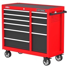 the craftsman's tool cabinet is red with black drawers and four roller casteors