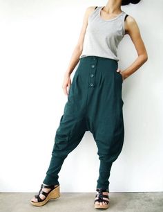 "* ALL ORDERS ARE SHIPPED VIA DHL EXPEDITED MAIL * Cotton jersey harem pants feature a drop crotch design with tapered pant legs, pleated front detail, side seam pockets, elastic back waistband, ribbed cuffs and four tucks at inseam create volume through leg. Roll up the ribbed cuffs hem for an utlra relaxed look! * Pull-on style * decorative pleats front and buttons detailed * Elastic back waistband provides a personal fit * Four tucks at inseam * Side seam pockets * Wide ribbed cuffs Measureme Baggy Tapered Pants With Button Closure, Green Baggy Bottoms For Fall, Green Bottoms With Button Closure, Casual Green Pants With Buttons, Baggy High-waist Buttoned Pants, Green Cotton Pants With Buttons, Baggy High-waist Pants With Buttons, Baggy High Waist Pants With Buttons, Green Bottoms With Buttons For Fall