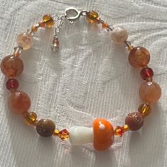 Have You Been To The Mushroom Festival? Adorable Orange Glass Mushroom Focal Bead Bracelet Swarovski Crystals Orange Glass Mushroom Bead Natural Stone Sterling Silver Adjustable Closure Nwt All Pieces Created By Hand At The Studio. . Smoke And Pet Free Happy To Answer Any Questions. Fall Theme Bracelets, Fall Bead Jewelry, Natural Stone Bracelet Ideas, Mushroom Bracelet Pattern, Fall Beaded Jewelry, Earthy Bracelets, Cute Bead Bracelet, Tiny Beads Bracelet, Funky Crafts