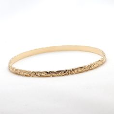 14K rose gold bangle bracelet, perfect for someone who love Hawaiian tropical flower and scroll design. 100% handmade. Engraved with Hawaii's Plumeria flower and scroll. Handmade with 14K gold. Ring width is 3mm. LOVIN' HAWAII JEWELRY FEATURES Made to Order. Handmade in Hawaii. Hand engraved design. Gold Karat: 14 Karat Available Gold Color: Rose Gold / Yellow Gold / White Gold Ready to Ship in 5 Business Days from HAWAII. Free inside message engraving. To make the piece more personal, you can a Elegant Etched Yellow Gold Bangle, 14k Gold Bangle With Intricate Design For Anniversary, Anniversary 14k Gold Bangle With Intricate Design, Elegant Etched Yellow Gold Bracelet, 14k Gold Bangle With Intricate Design As Gift, Elegant Gold Bangle With Engraving Option, Elegant Etched Rose Gold Jewelry, Rose Gold Engraved Bangle For Wedding, Elegant 14k Gold Bracelet With Engraving Option