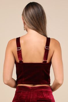 Keep things sultry-chic all night long in the Blank NYC Sneak Peak Burgundy Velvet Bustier Crop Top! Soft, plush velvet shapes this party-ready top with wide adjustable straps and a sweetheart neckline. Fitted, bustier-inspired bodice features seamed cups and flattering stitching before ending at an ultra-cropped hem. Hidden side zipper. Pair with the matching pants for a complete look! Fit: This garment fits true to size. Length: Size medium measures 9.75" from adjustable straps to hem. Bust: Works best for A to C cup sizes - consider sizing up for fuller bust. Waist: Fitted - very fitted at natural waist. Undergarments: May be worn with a strapless bra, adhesive bra, petals, or no bra. Fabric: Fabric has no stretch. Lined. Shell: 95% Polyester, 5% Spandex. Lining: 97% Polyester, 3% Spand Elegant Cropped Corset For Evening, Elegant Cropped Evening Corset, Fitted Cropped Corset For Party, Cropped Fitted Corset For Parties, Party Cropped Corset With Boned Bodice, Cropped Party Corset With Boned Bodice, Elegant Cropped Corset For Parties, Cropped Evening Corset With Corset Back, Cropped Corset With Corset Back For Evening