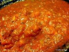 meatballs and tomato sauce in a skillet ready to be cooked on the stove