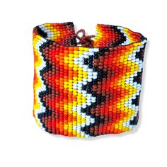 Lovely handmade wide, flat, Beaded Bracelet, black, orange and yellow colour, zig zag design. Adjustable size. Multi colour.  Bracelet size it's adjustable from 17 cm to 19 cm by 5 cm wide. Adjustable Black Cuff Bracelet With Colorful Beads, Black Bohemian Cuff Bracelet With Round Beads, Orange Beaded Bohemian Friendship Bracelets, Black Beaded Bohemian Cuff Bracelet, Bohemian Orange Beaded Friendship Bracelets, Orange Bohemian Beaded Friendship Bracelets, Handmade Adjustable Orange Cuff Bracelet, Handmade Orange Adjustable Cuff Bracelet, Adjustable Orange Cuff Bracelet