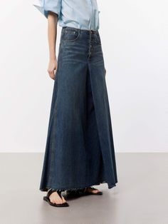 MO&Co. Women's A-line Maxi Denim Skirt This denim skirt features an A-line maxi silhouette, a flattering and versatile style that falls gently away from the body. Crafted from premium cotton, this skirt features a pleated and raw hem design that adds a unique and trendy touch, while the deep blue hue gives it a classic and timeless look. Pair with a cute top or tucked-in blouse for a chic outfit. Features : - Mid waist A-line maxi silhouette- Classic five pocket design- Pleated and raw hem desig A-line Denim Bottoms For Spring, Spring A-line Denim Bottoms, Spring A-line Denim Skirt, Wide Leg Denim Skirt In Medium Wash, Medium Wash Wide Leg Denim Skirt, Medium Wash Denim Wide Leg Skirt, Full-length Denim Blue Maxi Skirt, Spring Dark Wash Wide Leg Maxi Skirt, Chic Medium Wash Denim Maxi Skirt