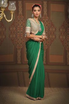 Emerald green pure crepe saree, embellished with gota, dori and badla work and contrasting baby pink borders. Comes with silk chanderi blouse embroidered padded blouse and tasseled dupatta. - Aza Fashions Green Embellished Pre-draped Saree For Wedding, Embellished Pista Green Pre-draped Georgette Saree, Green Chinon Pre-draped Saree For Navratri, Green Dola Silk Pre-draped Saree For Reception, Green Dola Silk Blouse Piece For Reception, Designer Green Chinon Blouse Piece, Designer Green Chinon Blouse, Embellished Green Georgette Saree, Green Embellished Semi-stitched Pre-draped Saree