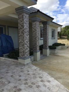 a house that has some plants in front of it and a blue tarp on the ground