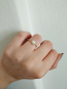 14K 9K Gold Solitaire Pearl Ring, Minimalist pearl ring, Dainty pearl ring, Stacking ring, Promise ring, Engagement ring, Gift for her, 14K Rose gold ring, Gift for her, Anniversary ring, FREE EXPRESS SHIPPING Beautiful and delicate white pearl ring made in 14K or 9K solid gold. The pearl is natural and not colored. Whisper...Always on trend! ;) -------------------------------------------------- D E T A I L S 14K or 9K Solid Gold Natural White Pearl 5mm Band width 1.4mm ------------------------- 14k Yellow Gold Rings With Pearl Charm, Minimalist Everyday Yellow Gold Pearl Ring, Everyday Minimalist Yellow Gold Pearl Ring, Pearl Drop Promise Ring, Gold Everyday Pearl Ring With Pearl Drop, Dainty Pearl Drop Ring For Everyday, Dainty Everyday Pearl Ring With Pearl Drop, Everyday Gold Pearl Ring With Pearl Drop, Dainty Everyday Pearl Drop Ring