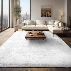 a living room filled with furniture and a white rug on top of a hard wood floor