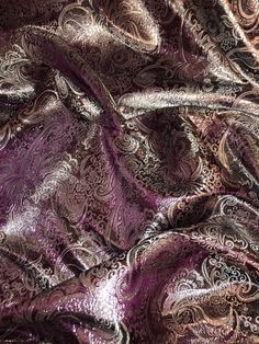 an image of a purple and silver paisley print fabric with metallic foil on the side