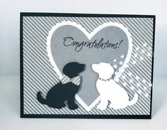 a black and white card with a dog and a heart on the front that says congratulations