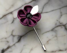 Elevate your style game and add a touch of sophistication to any outfit with this exquisite men's lapel flower. Made from the finest materials and crafted with the utmost care and attention to detail, this accessory is the perfect finishing touch to your attire. With its striking color and intricate design, this lapel flower is a statement piece that is sure to catch the eye of anyone who sees it. The bright, bold hues are perfect for adding a pop of color to a monochrome outfit, while the subtl Elegant Purple Brooches With Flower Decoration, Elegant Purple Flower Brooch, Purple Flower Brooch For Formal Occasions, Elegant Flower Decoration Lapel Pin As Gift, Elegant Floral Brooch For Formal Occasions, Elegant Flower Decorated Pins For Gifts, Elegant Flower Decorated Pins As Gifts, Elegant Flower Decoration Pins As Gifts, Elegant Flower Decoration Pin As Gift