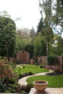 a garden with lots of green grass and trees