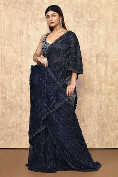 Navy attached cancan lehenga saree with thread, cutdana, bead embroidery in chevron pattern. Paired with sleeveless embroidered blouse.
Components: 2
Pattern: Embroidery
Type Of Work: Thread, cutdana, bead
Neckline: Leaf neck
Sleeve Type: Sleeveless
Fabric: Crepe, Double Georgette, Net
Color: Blue
Other Details: 
Back tassel tie-up
Cutwork bordered saree
Occasion: Bride - Aza Fashions Ritika Mirchandani, Cancan Lehenga, Drape Saree, Lehenga Saree, Beaded Neckline, Pattern Embroidery, Blouse For Women, Blouse Online, Saree With Blouse