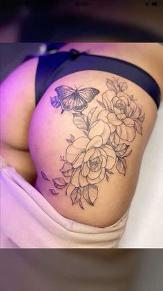 a woman's thigh with flowers and butterflies on it