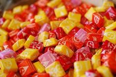 a pile of red and yellow candy cubes