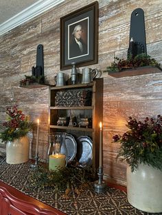 a dining room table with plates and silverware on it's shelf next to a framed portrait