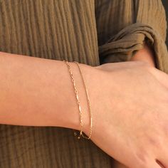 This is a set of layering bracelets inspired by our Shoreline and Shoreline Toggle Necklace. These bracelets look stunning when layered together but also when each bracelet is worn individually or with other bracelets to complete your fabulous look. Made out of high quality gold filled materials and perfect for everyday wear. One set of two chain bracelets: Spring ring clasp (6mm) 14K gold filled chain 1" extender option available Nickel-free Trendy Rose Gold Bracelet With Delicate Chain, Dainty Adjustable Bracelets For Layering, Adjustable Chain Bracelets For Layering, Dainty Stackable Bracelets For Everyday, Chic Bracelet With Delicate Chain For Gift, Dainty Everyday Stackable Bracelets, Adjustable Dainty Paperclip Bracelet, Gold Stackable Wrap Bracelet For Stacking, Adjustable 14k Gold-filled Bracelets For Layering