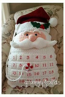 a crocheted santa clause is sitting on a couch with the date for christmas