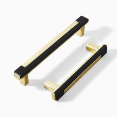 two black and gold handles on a white background, one has a square handle in the middle