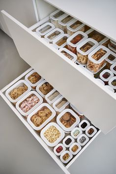 two white drawers filled with food on top of each other