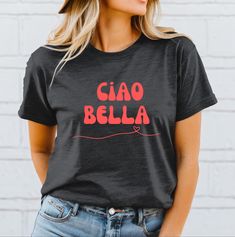 This Ciao Bella T-Shirt exudes a chic and sophisticated vibe, perfect for fashion-forward individuals looking to make a statement. It can be worn casually or dressed up for semi-formal occasions, making it versatile for any wardrobe. Ideal for those who appreciate Italian culture and style. Perfect for vacations, dinner parties, and casual outings. Product features - Made with 100% Airlume combed and ring-spun cotton for lightweight comfort and breathability - Retail fit for a classic and neat s Italy Graphic, Italia Shirt, Italy Shirt, Italian Shirts, Italian Gifts, Ciao Bella, Italian Culture, Italian Language, Formal Occasion