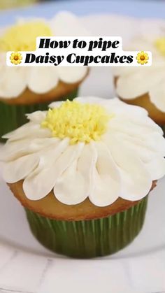 three cupcakes with white frosting and yellow flowers on top are sitting on a plate