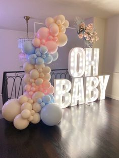 a large balloon arch with the words oh baby on it