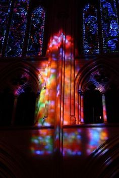 the light is streaming through the stained glass windows in this cathedral, and it appears to be brightly colored