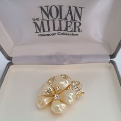 Vintage Nolan Miller Brooch Lucite Flower Petals  Clear Color Crystals Glamour Collection in Original Box.Stunning, elegant, multileveled design with high-quality, exceptional crystals. A luxurious, high-end, designer piece in an original box with all the original certificates. In pristine pre-owned condition. For new arrivals check out the store's Instagram account https://www.instagram.com/helensjewellerybox/ Thank you for looking and if you have any questions please don't hesitate to ask :) All jewellery is photographed in natural light and may have light scratches due to age and wear* Luxury Elegant Lucite Jewelry, Luxury White Flower Brooch, Nolan Miller, Color Crystal, Flower Petals, Instagram Account, Natural Light, Brooch Pin, Brooches