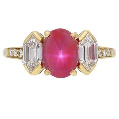 Vintage star ruby and diamond ring by Tiffany & Co. Set centrally with an oval cabochon natural unenhanced Burmese star ruby in an open back claw setting with an approximate weight of 2.47 carats, flanked by two hexagonal step cut diamonds in open back rubover settings with a combined weight of 0.80 carats and further enhanced by six round brilliant cut diamonds in open back grain settings with a combined weight of 0.12 carats. The total approximate diamond weight is 0.92 carats, to a fancy thre Tiffany Engagement Ring, Diamond Three Stone Ring, Diamond Gold Ring, Ruby And Diamond Ring, Asscher Cut Diamond, Gem Diamonds, Platinum Diamond Rings, Three Stone Ring, Vintage Star