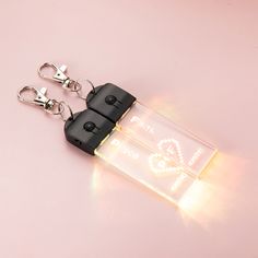 a pair of keys that are attached to some type of light up keychain