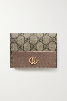 Gucci's wallet is ideally sized to slip into a clutch or coat pocket. Made from textured-leather and the house's iconic coated-canvas, it's decorated with a gold logo plaque and opens to reveal six card slots, a bill compartment and a zipped pocket. Classic Gucci Beige Wallet, Classic Beige Gucci Wallet, Elegant Beige Gucci Wallet, Gucci Travel Wallets With Card Slots, Gucci Wallets With Card Slots For Travel, Gucci Beige Wallet, Beige Gucci Wallet For Everyday Use, Luxury Card Holder With Coin Pocket For Daily Use, Rectangular Gucci Wallet For Travel