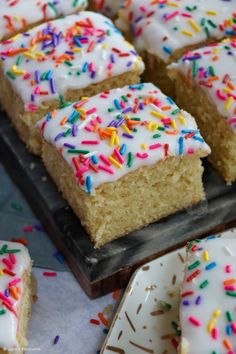 several pieces of cake with white frosting and sprinkles