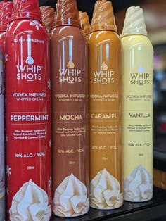 six different types of whip shots are lined up in a row on the counter top