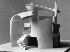 a black and white photo of a model of a house with spiral staircase leading up to it