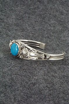 This turquoise and sterling silver bracelet was made by Navajo silversmith Raymond Delgarito. The inside is signed RD and stamped sterling.Size: 5 1/2" (will fit up to a 6 3/4" wrist)Gap: 1 1/4"Width: 3/4" tapered to 1/4"Free shipping on all orders! We ship with USPS and always include tracking. All orders ship within a day of payment.Returns are accepted up to 30 days after you receive your order. Just send us a message. Our shop offers cash back or store credit. The item must be returned in ne Bohemian Engraved Turquoise Sterling Silver Bracelet, Bohemian Turquoise Engraved Sterling Silver Bracelet, Southwestern Style Turquoise Bracelet Stamped 925, Collectible Bohemian Blue Sterling Silver Bracelet, Handmade Turquoise Sterling Silver Southwestern Bracelet, Unique Engraved Blue Bracelets, Turquoise Oyster Bracelet In Sterling Silver, Turquoise Sterling Silver Oyster Bracelet, Southwestern Blue Cuff Bracelet Stamped 925