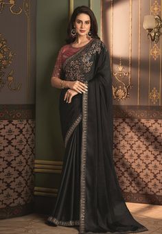 Drape yourself in elegance with our exquisite black chiffon saree, delicately crafted for the sophisticated wardrobe. The saree's lightweight fabric is perfect for any season, allowing for graceful movements and a stunning silhouette. Adorned with intricate embroidery and a shimmering border, this saree embodies the perfect blend of traditional design and modern flair. Its rich hue is a tribute to timeless fashion, making it an ideal choice for weddings, festivities, or a stylish day out. Indulg Semi-stitched Black Art Silk Blouse Piece, Black Pre-draped Saree With Pallu For Festive Occasions, Formal Black Pre-draped Saree With Resham Embroidery, Elegant Black Silk Pre-draped Saree, Elegant Georgette Pre-draped Saree With Embroidered Border, Formal Saree With Embroidered Border, Festive Black Embroidered Pre-draped Saree, Black Georgette Pre-draped Saree With Resham Embroidery, Black Art Silk Saree With Traditional Drape