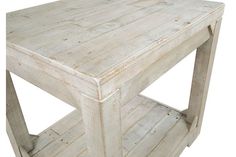 an old white wooden table with one shelf on the bottom and two shelves below it