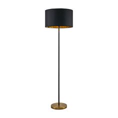 a black and gold floor lamp on a white background with a light shade over it