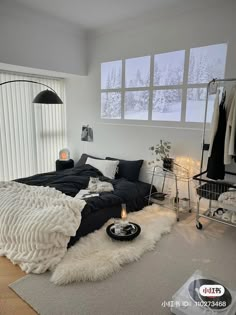 a bedroom with a record player on the floor and a bed in front of it